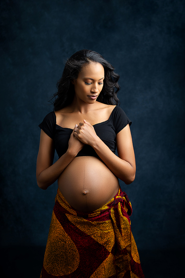 pregnancy photo of a mom in a cropped black top and wearing a wrapped bottom by Baltimore Maternity Photographer, Angela