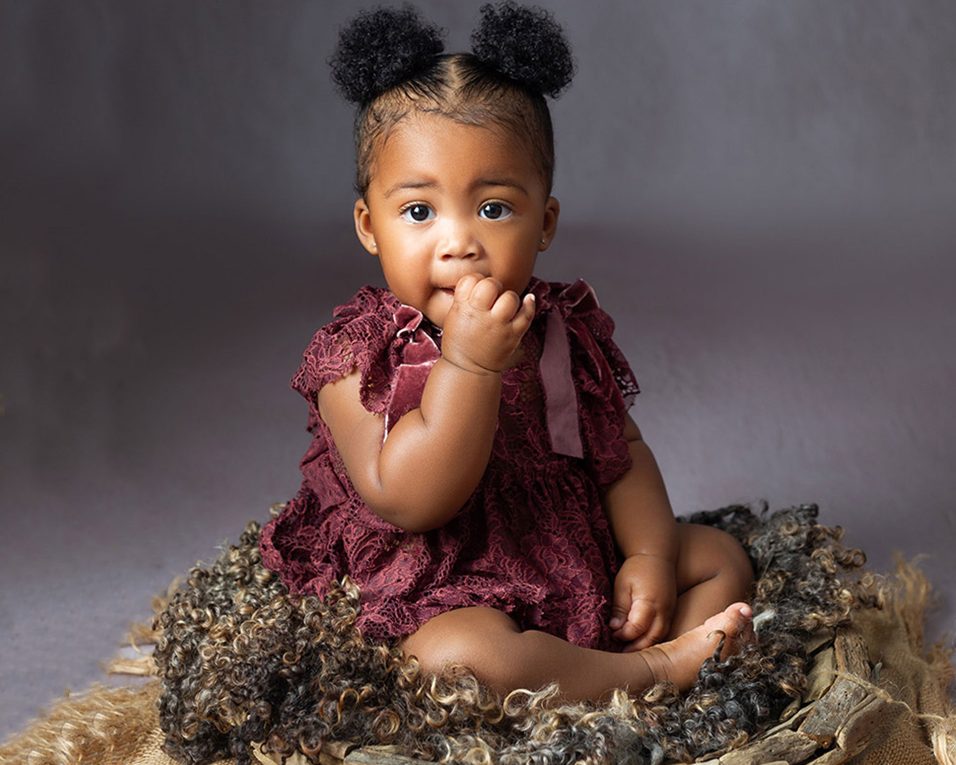 one year old sitter session of little girl wearing a maroon dress from baltimore photographer Angela 