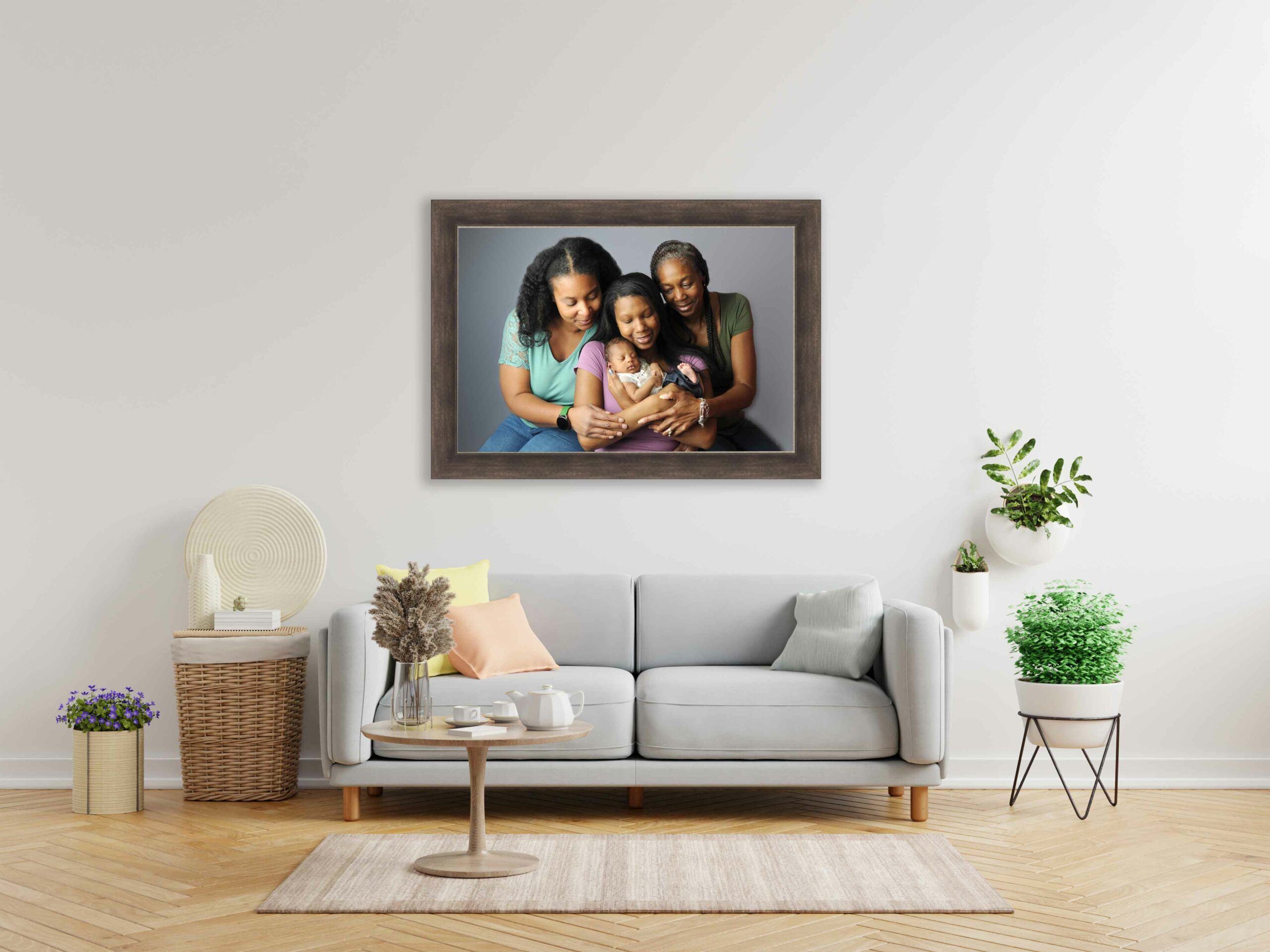 maryland newborn family session of a baby being held in a generational image framed above the couch